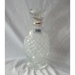 A cut glass decanter and stopper with silver mounted neck, 9" high. B'ham 1928