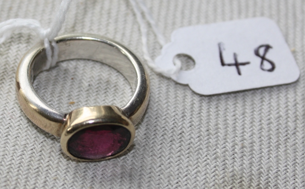 An unusual gold & silver 1960's ring set with an oval almandine garnet - size M - 7.8gms