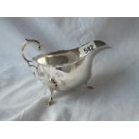 An oval sauce boat with leaf capped handle, 6" long. Chester 1899 175gms.