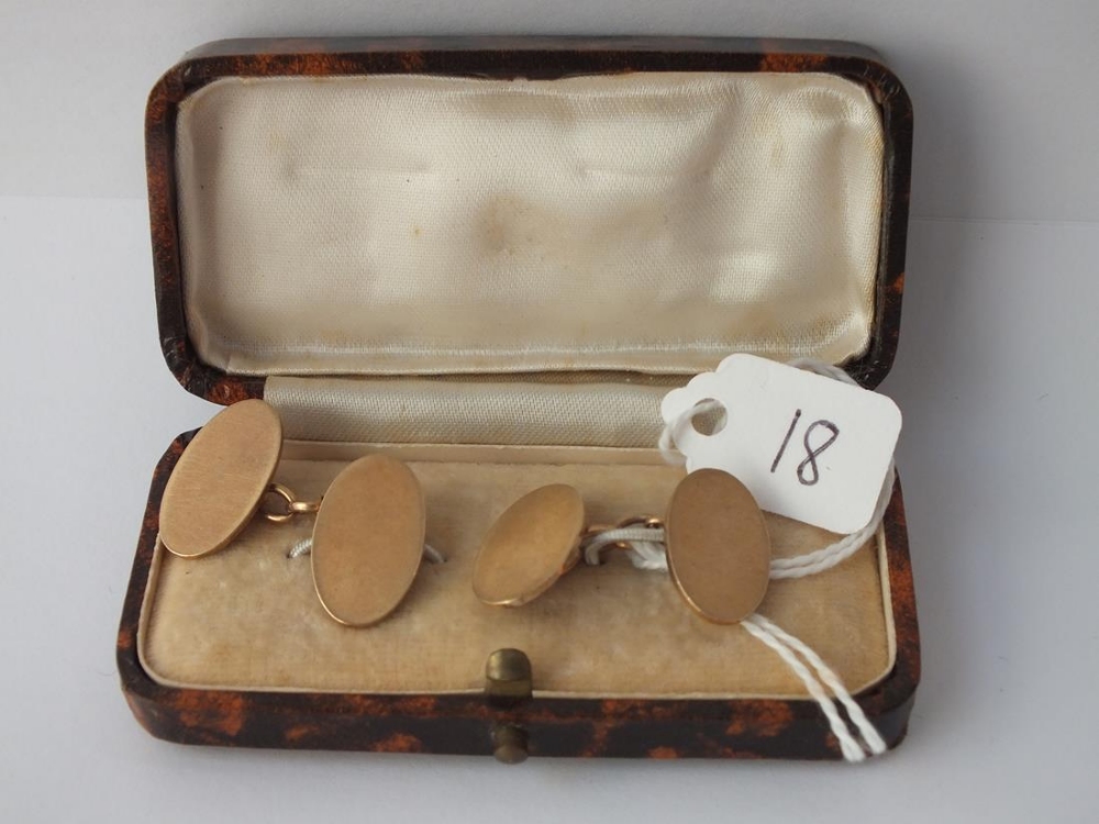 A boxed pair of plain oval cufflinks in 9 ct - 8.6gms.