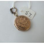 A circular 9ct engraved locket - 4.3gms