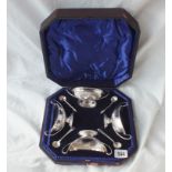 A boxed set of four boat shaped salts with loop handles, 5" wide. Sheffield 1897 by GH and two pairs