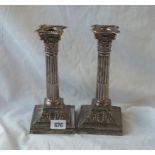 A pair of late Victorian candlesticks on fluted stems with capital and with detachable nosels, 8.