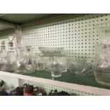 SHELF OF GLASS JUGS, DECANTERS, ETC