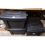 THREE BLACK STORAGE TRAVEL TRUNKS ON WHEELS