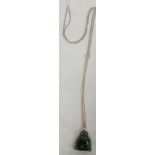 A GREEN HARD STONE PEDANT ON SILVER NECK CHAIN