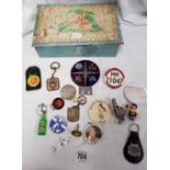 TIN BOX CONTAINING MISCELLANEOUS PIN BADGES, A PSV DRIVER BADGE, A WHISTLE AND METAL E-CHAINS