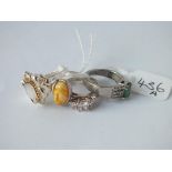 Four silver stone set rings