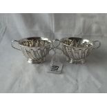 A pair of spirally-fluted two-handled salts on rim foot - Sheffield 1902 by GH - 83gms