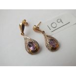 A pair of amethyst & diamond drop earrings in 9ct - 2.1gms
