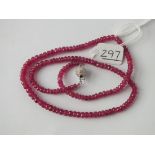 A STRING OF RUBY FACETED BEADS WITH ROUND DIAMOND CLASP