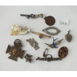 A bag of sundry jewellery items including pendants, brooches, medal etc.