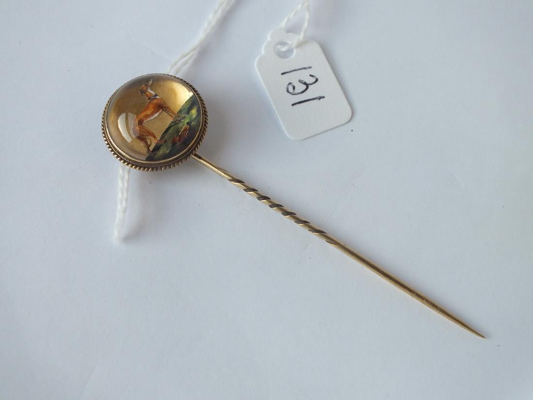 A ANTIQUE VICTORIAN ESSEX REVERSE INTAGLIO STICK PIN OF A GREYHOUND SET IN 15CT GOLD