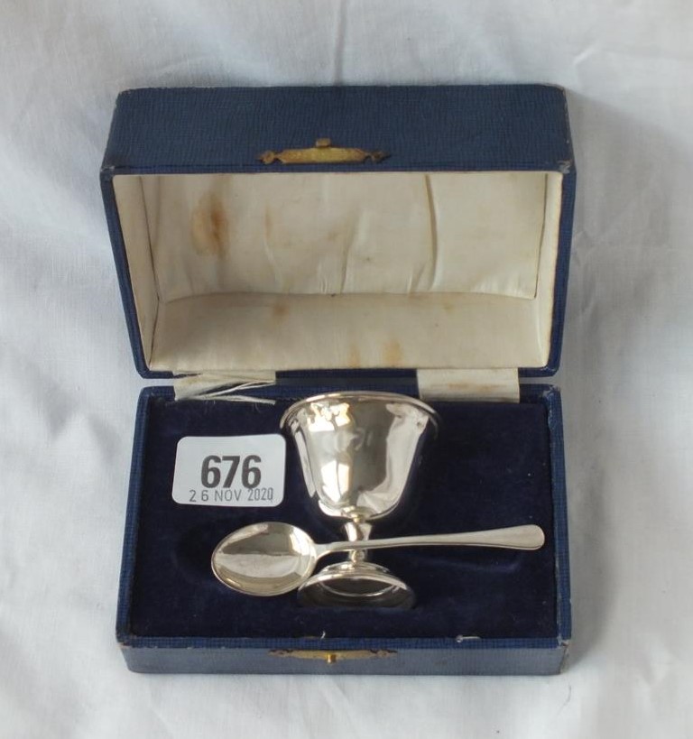 A boxed christening set of an egg cup and spoon