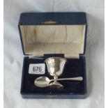 A boxed christening set of an egg cup and spoon