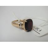 A garnet & white topaz ring in 9ct - size N - 5.8gms