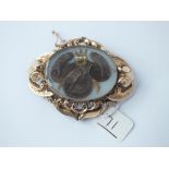 A fine quality large antique mourning brooch set with pearl dressed hair