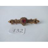 An antique bar brooch set with red paste with Australian hall marks in 9ct (pin missing)