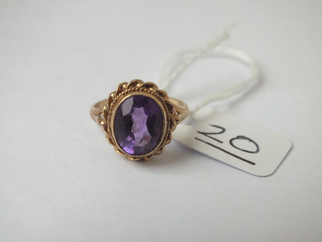 A amethyst ring with rope border in 9ct - size J - 2.5gms