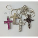 Four silver stone set crosses on chains