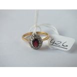 A garnet & diamond ring in 18ct gold - size O - 3.4gms