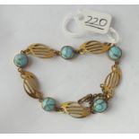 An arts & crafts gilt bracelet