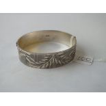 A silver engraved bangle - 36gms