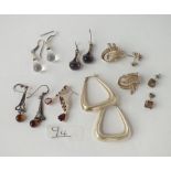 Eight pairs of silver earrings