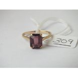 A large purple stone set ring in 9ct - size S - 2.5gms