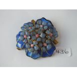 A large vintage coloured glass brooch