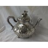 A GOOD VICTORIAN TEAPOTEMBOSSED WITH BALL FEET AND CRESTED - London 1848 by WKR 695 gms.