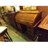 A small late Victorian walnut twin pedestal roll top desk