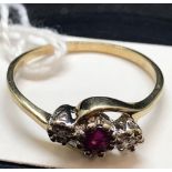 A 3 STONE RUBY & DIAMOND CROSS OVER RING SET IN 9ct