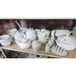 SHELF OF WHITE CERAMIC TABLEWARE