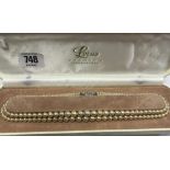 A BOXED GRADUATED 2 ROW PEARL NECKLACE WITH PASTE CLASP