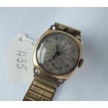A gents wristwatch in 9ct on metal expanding strap