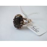 A brown stone fancy ring in 9ct - size M