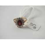 An oval red & white stone cluster ring in 9ct - size M