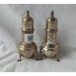 A pair of pepper casters each standing on three pad feet marked sterling - 4.5" high - 163gms