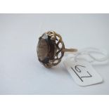 A plain brown stone ring in 9ct - size O - 3.6gms