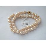 A string of pearls with 9ct clasp