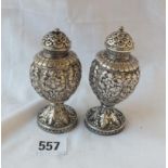 A pair of Indian white metal casters with chased decoration - 4" high - 171gms