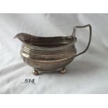 An oval Georgian cream jug with engraved body - London 1812 - 137gms