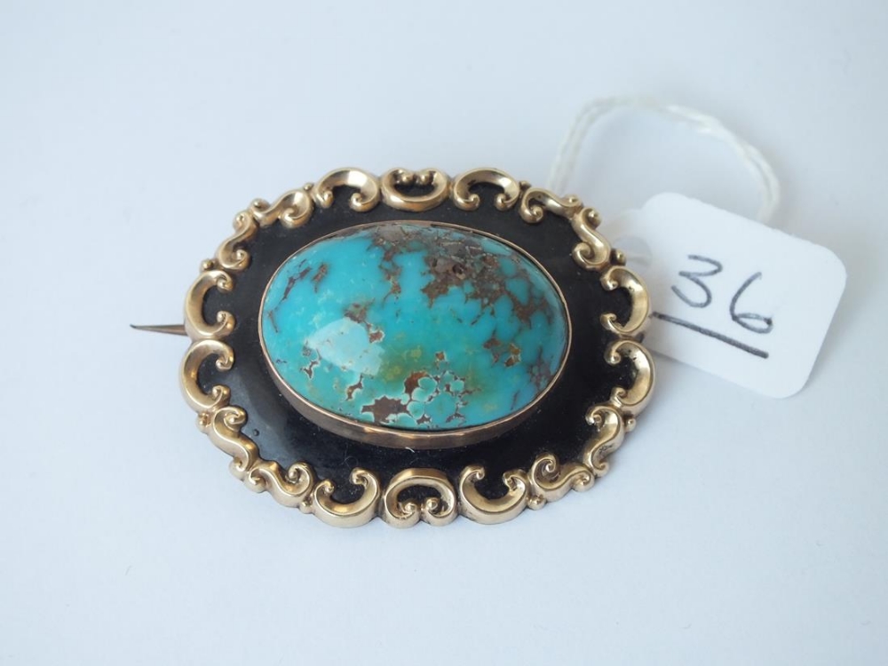 A gold mounted turquoise enamel brooch