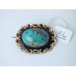 A gold mounted turquoise enamel brooch