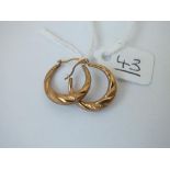 A pair of hoop earrings in 9ct