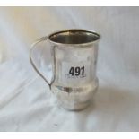 A Liberty & Co stylish mug with simple scroll handle - 3.5" high - Birmingham 1921 - 113 gms.