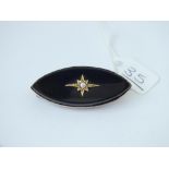 An antique gold onyx-set brooch