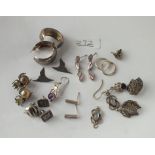 Twelve pairs of silver earrings