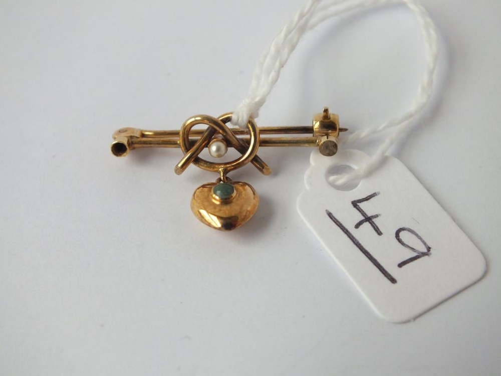 An antique heart and lovers knot brooch in 15ct gold